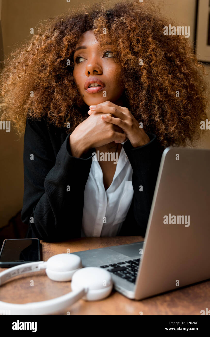 Young woman with laptop in a cafe Stock Photo