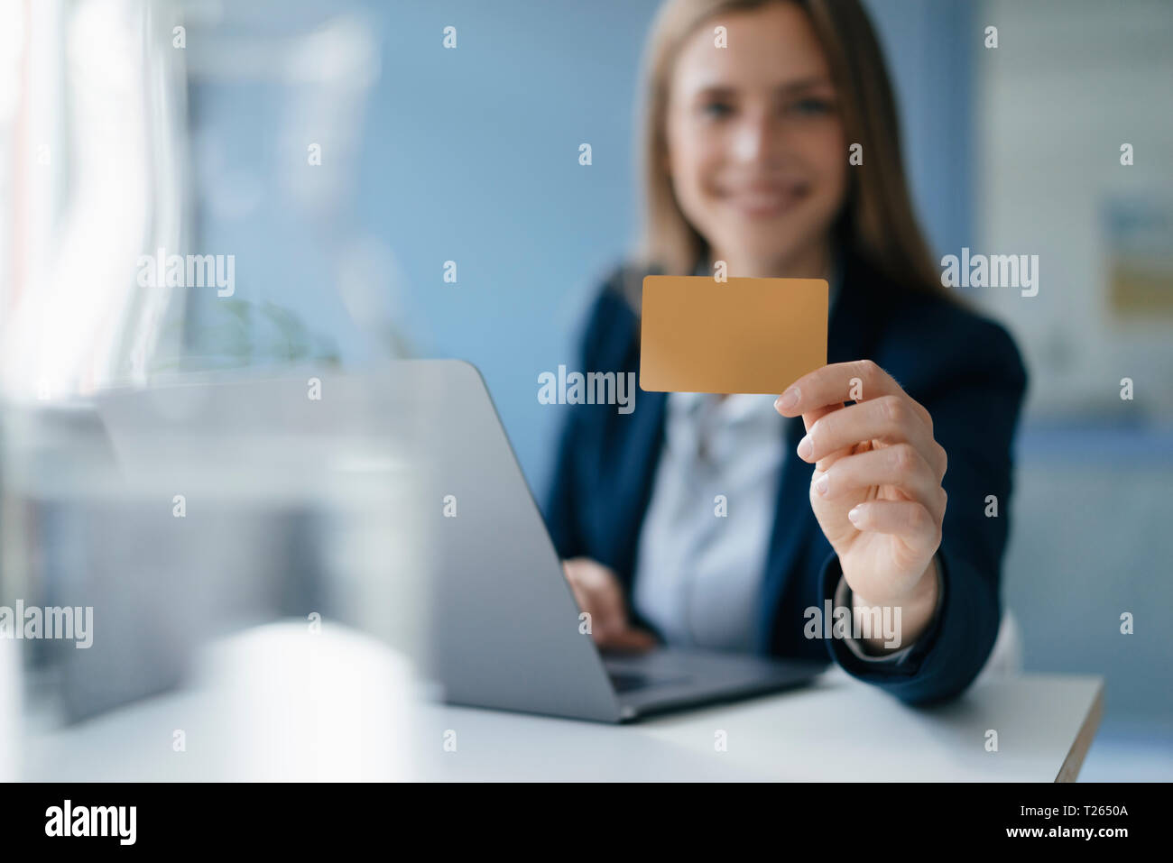 Young businesswoman doing online payment, showing her credit card Stock Photo