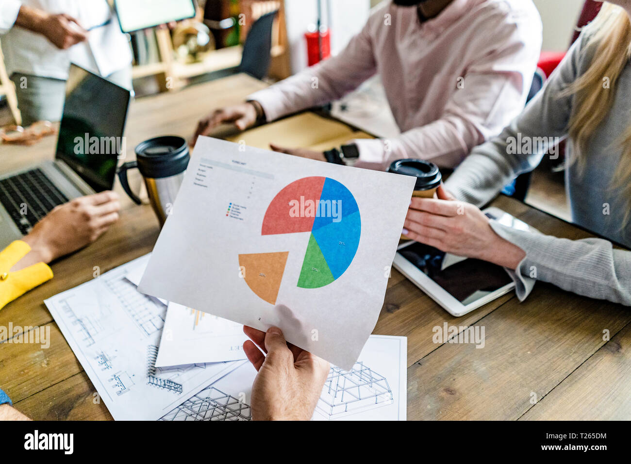 Business team having a meeting analyzing pie chart Stock Photo