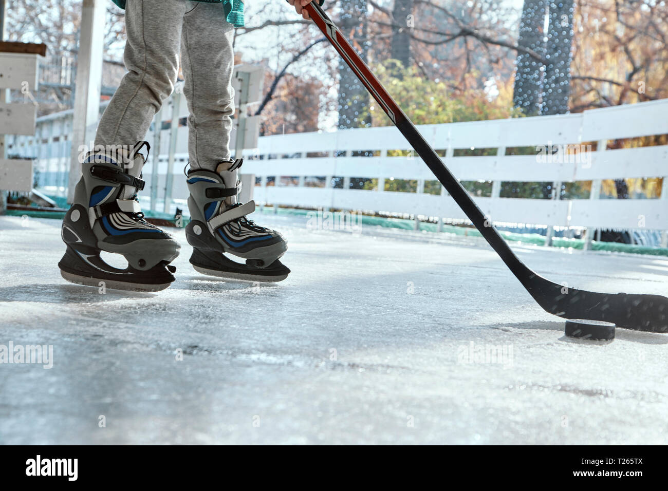 Boy playing ice hockey, low section Stock Photo