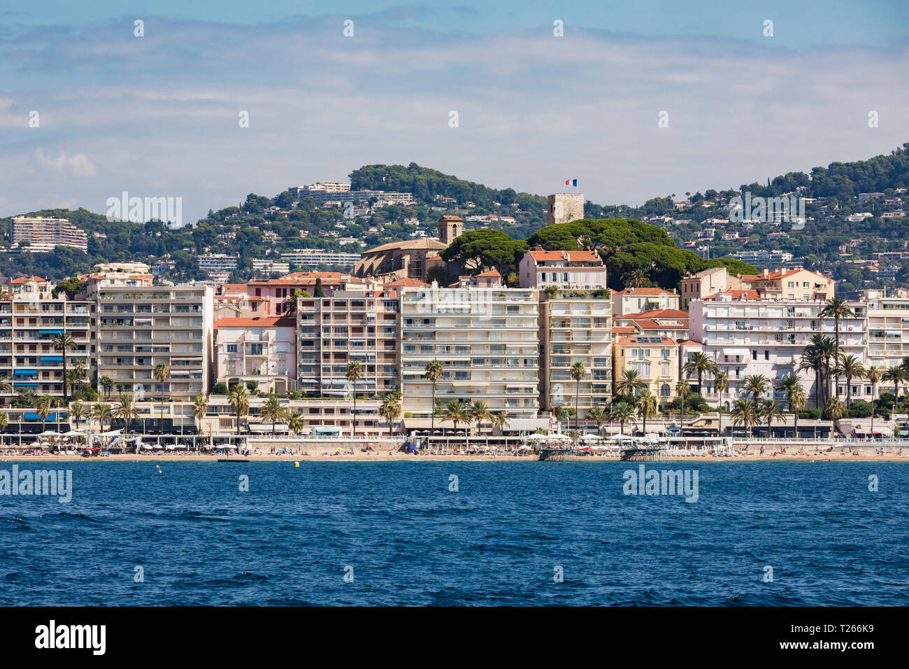 France, Provence-Alpes-Cote d'Azur, Cannes, apartment buildings at the beach, Le Suquet old town in the background Stock Photo