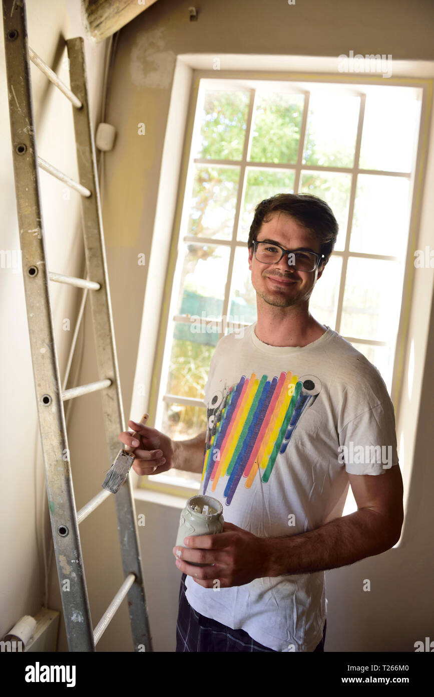 Portrait of smiling young man renovating his home Stock Photo