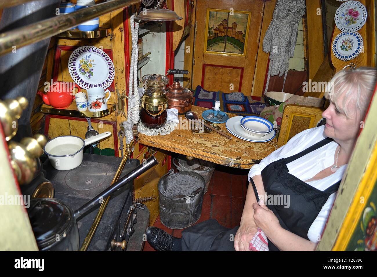 Lady inside an old canal boat at the Black Country Living Museum, an open-air museum of historic buildings in Dudley, West Midlands, England UK Stock Photo