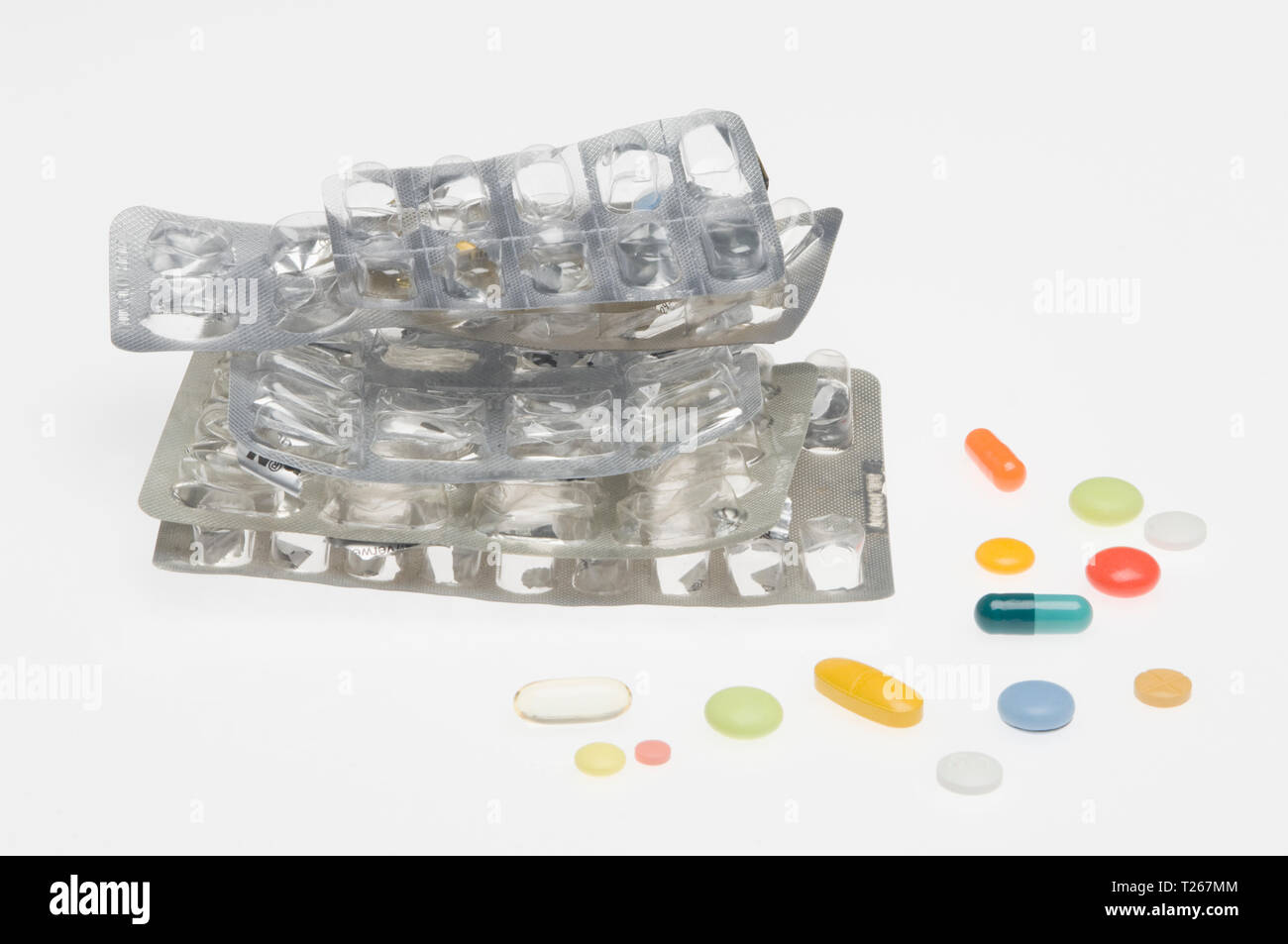Empty blister pack and colourful pills Stock Photo