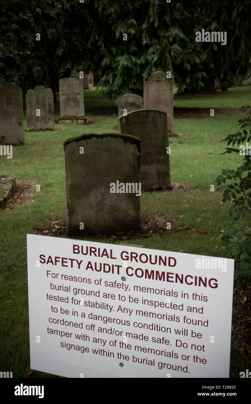 Kelso chruch graveyard in Scotland. Notice of a safety audit (many of the gravestones were laid flat after this for safety). Stock Photo