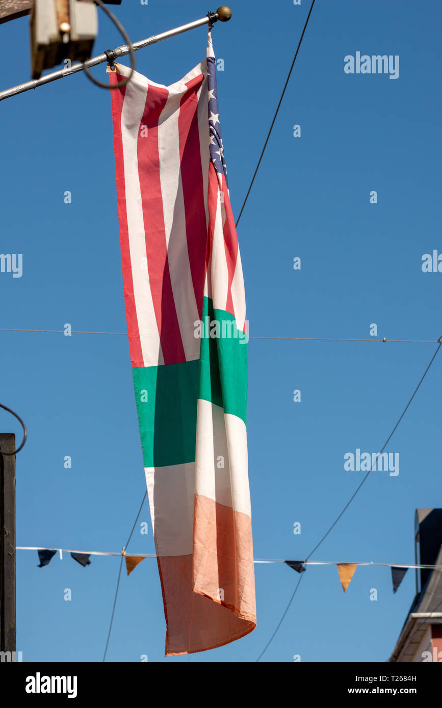 Irish tricolour fictional Irish American flag waving against blue sky as a restaurant advertisement. Killarney County Kerry Ireland. Stock Photo