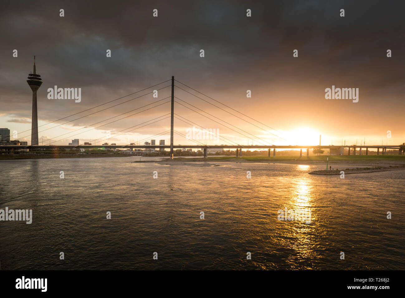Germany, Duesseldorf, Oberkassel Bridge with Media Harbour in the background at twilight Stock Photo
