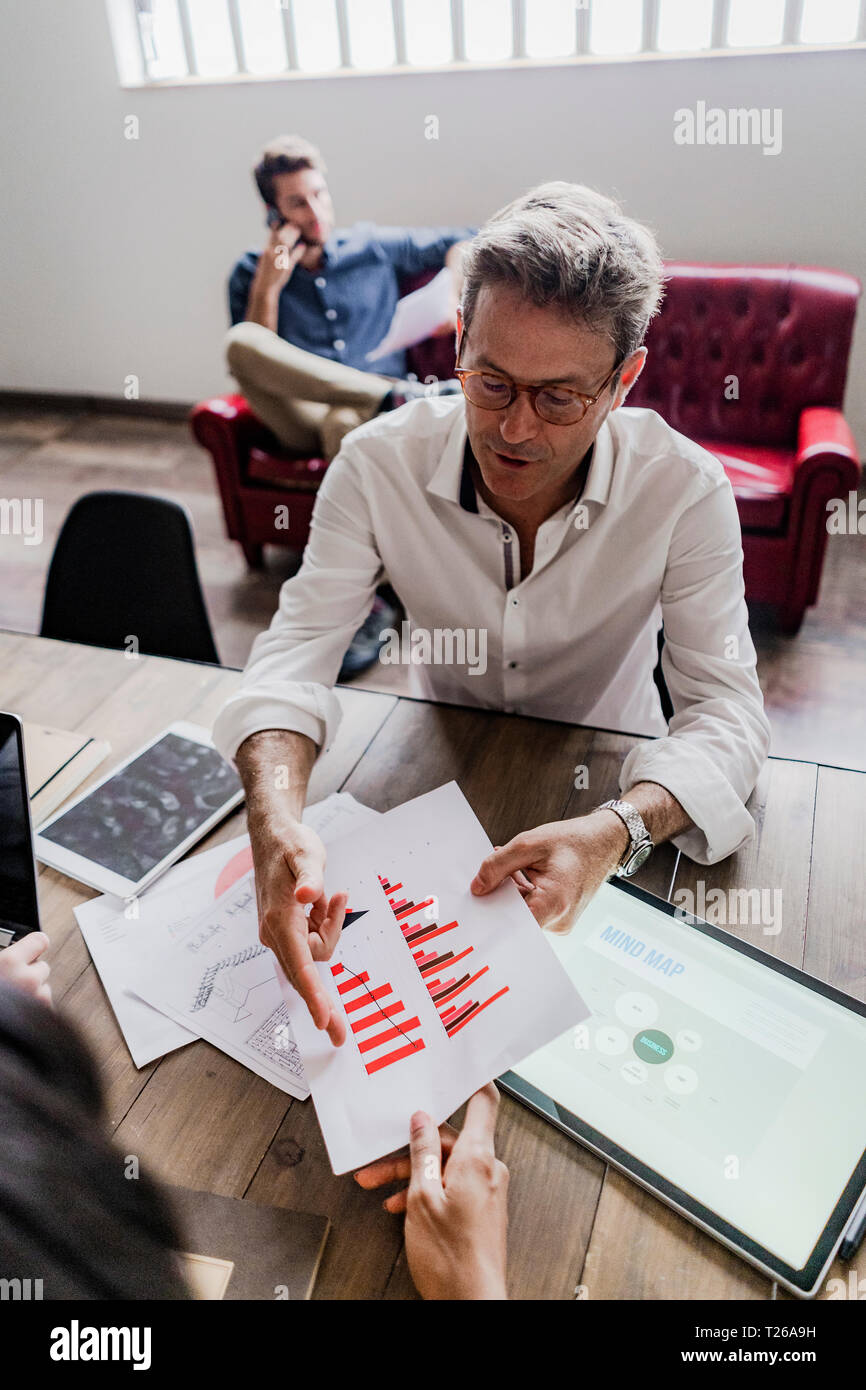 Businessman analyzing a bar chart in office Stock Photo