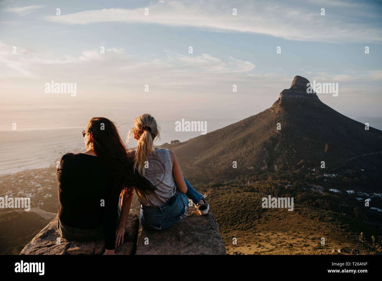 Women sitting on rock hi-res stock photography and images - Alamy