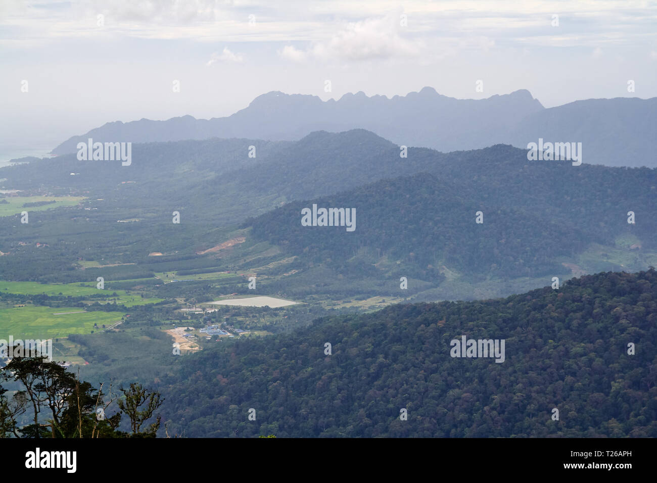 Amazing landscape view from the observation tower at Gunung Raya, the highest point in Langkawi, Malaysia. Distant mountains in the mist and the ocean Stock Photo