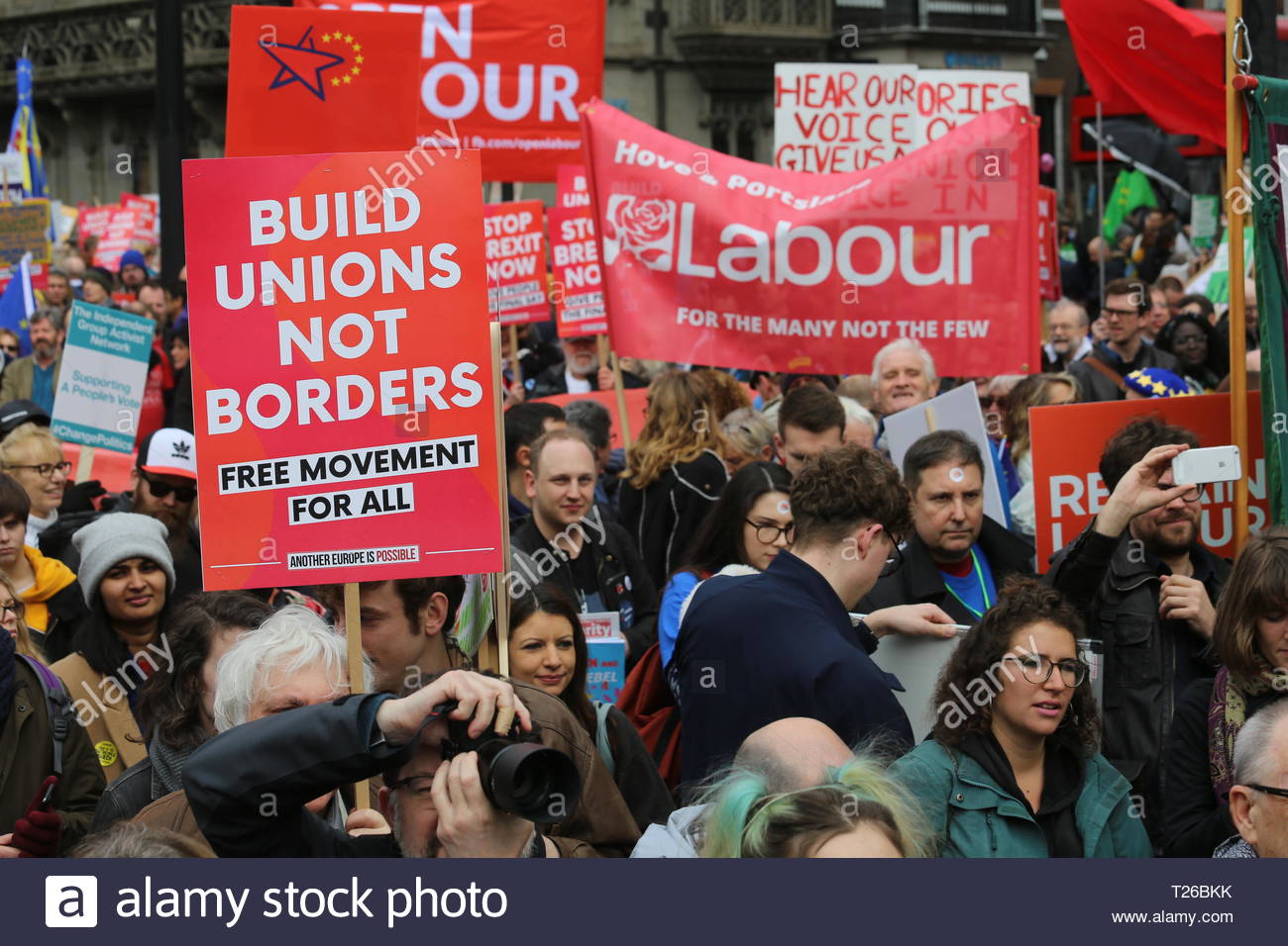 Protesters hold red union flags up in the air at a People's Vote march in London Stock Photo