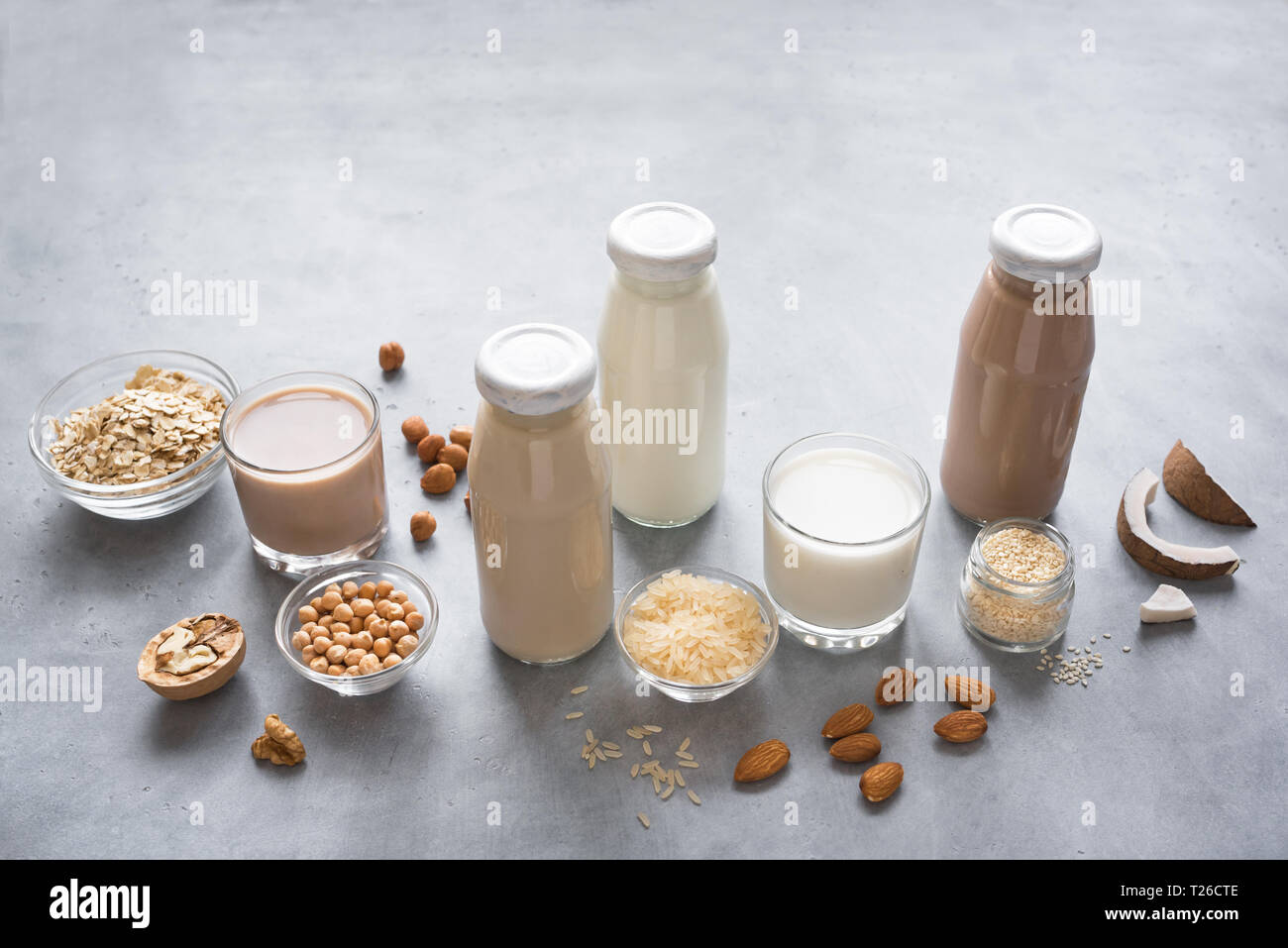 Various vegan plant based milk and ingredients, top view, copy space