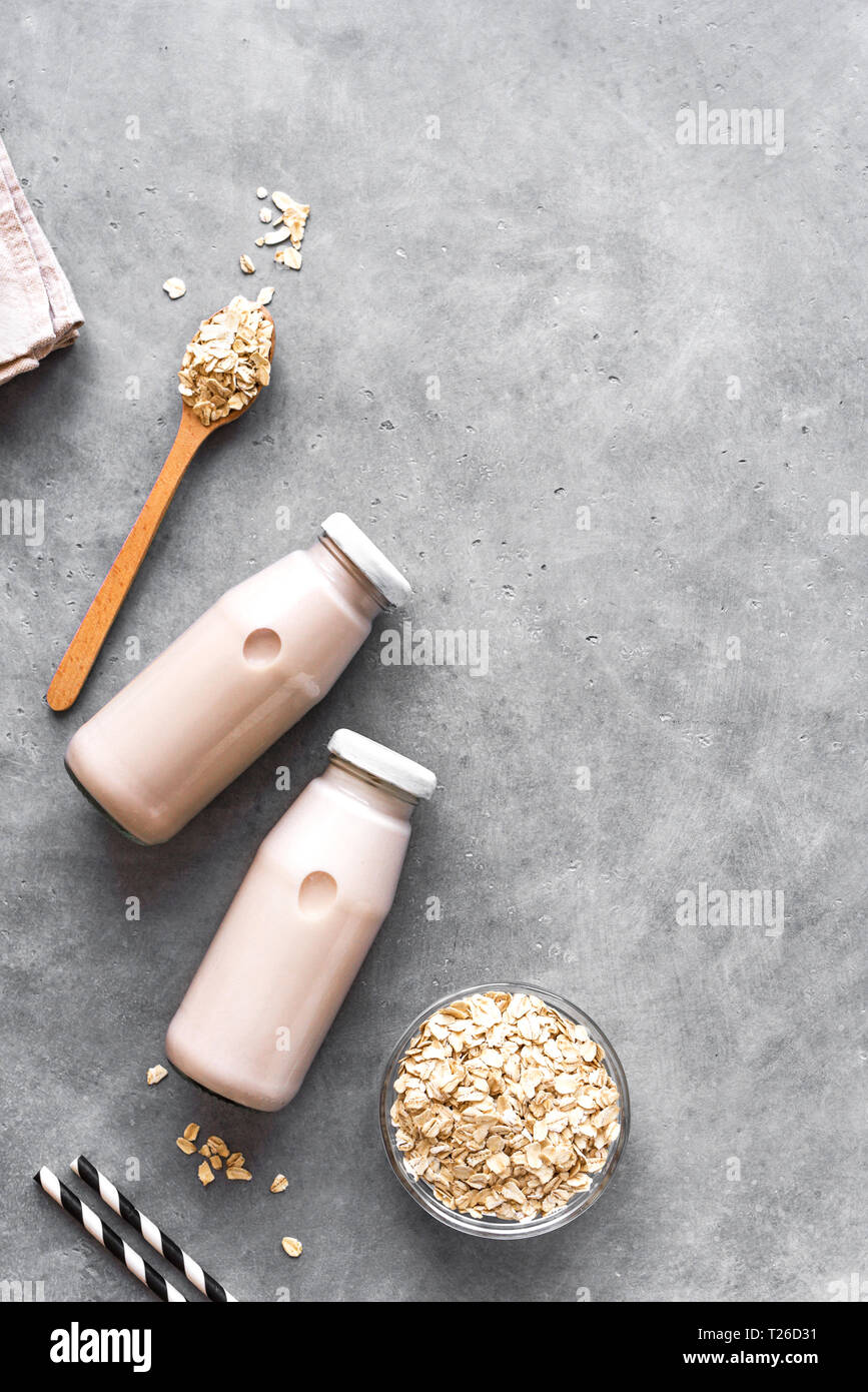 Oat milk alternative on gray background, copy space, top view. Healthy