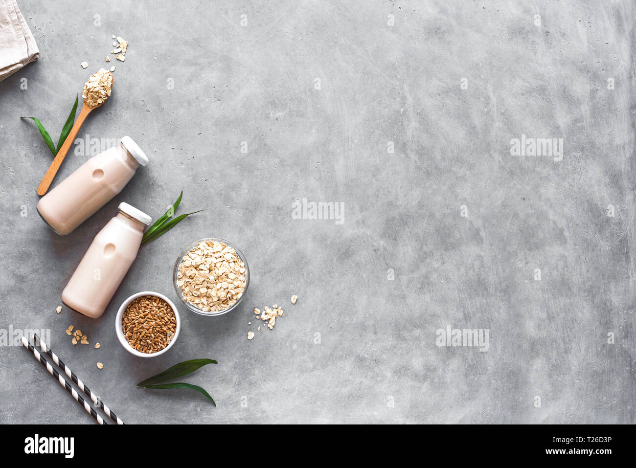 Oat milk alternative on gray background, copy space, top view. Healthy