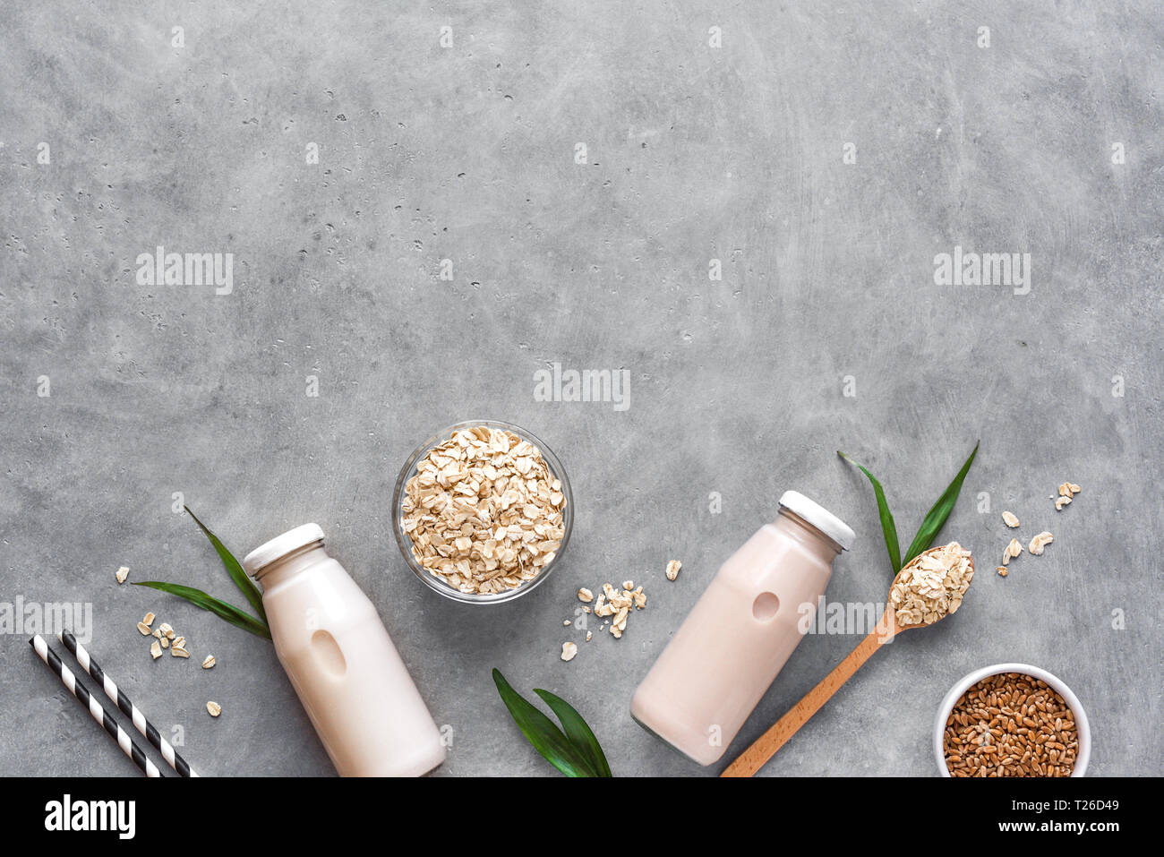 Oat milk alternative on gray background, copy space, top view. Healthy