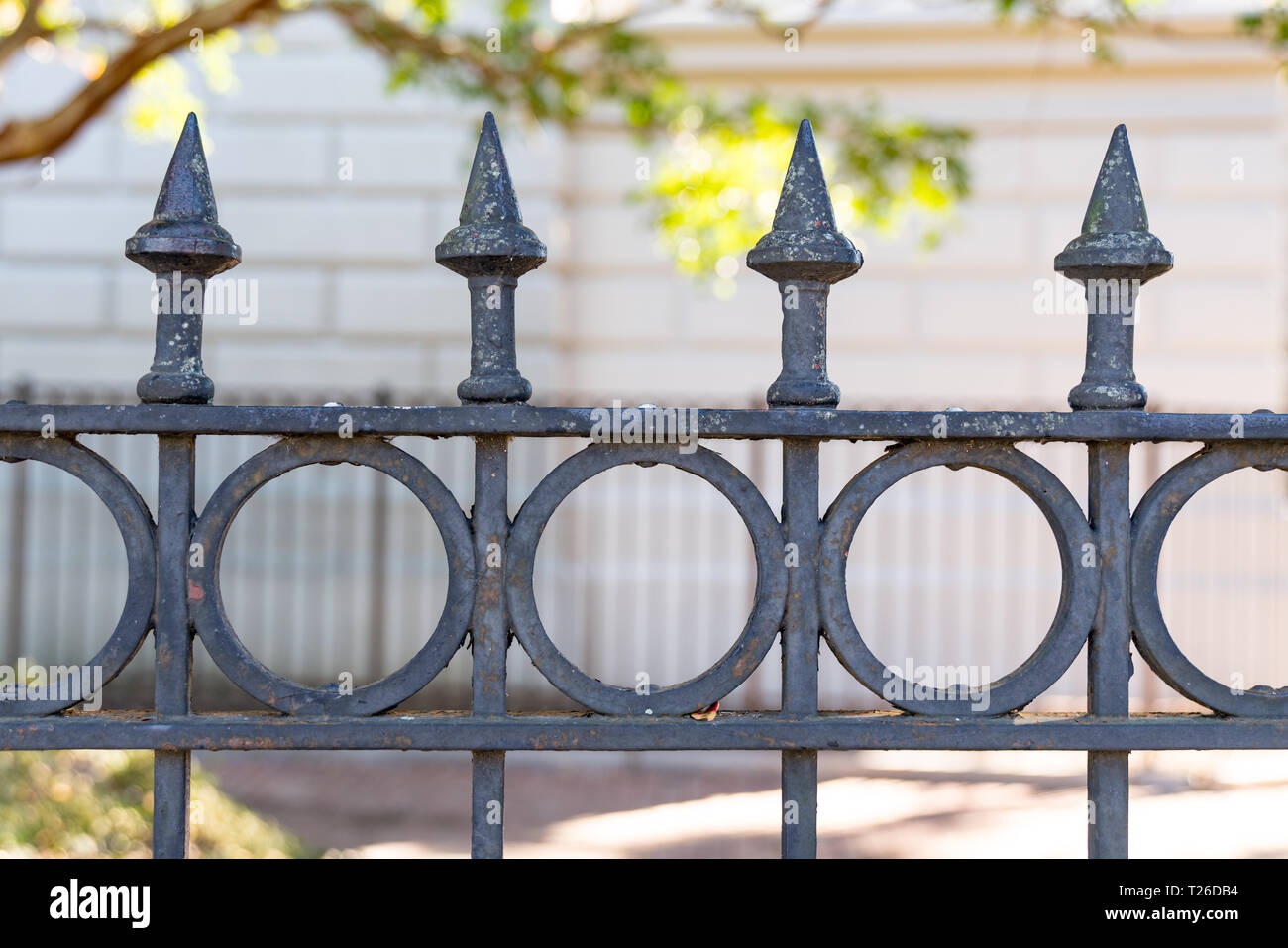 Detail of the top of an ornate iron fence Stock Photo
