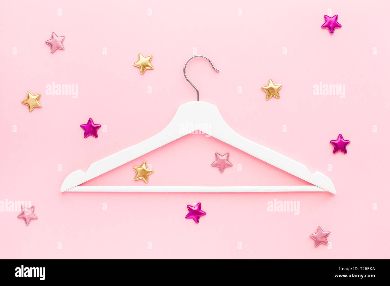 Creative top view flat lay white wooden hangers pastel millennial pink ...