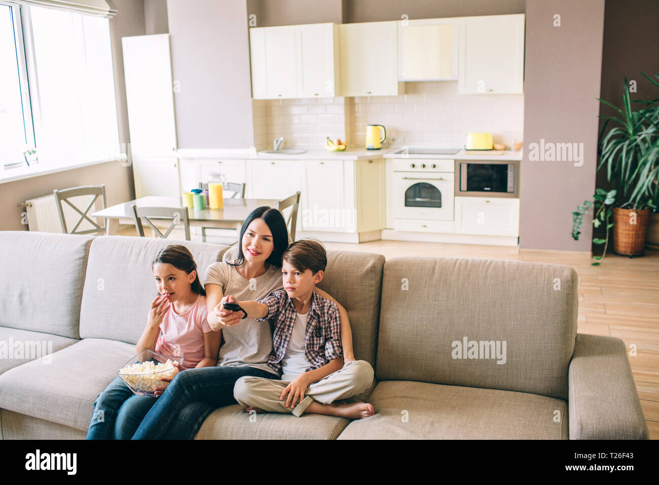 Woman Is Sitting With Her Kids And Looking Straight Girl Eats