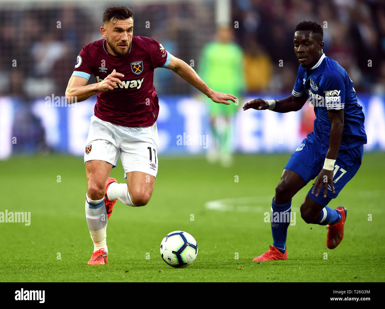 West Ham United's Robert Snodgrass (left) and Everton's Idrissa Gueye battle for the ball during the Premier League match at London Stadium. Stock Photo