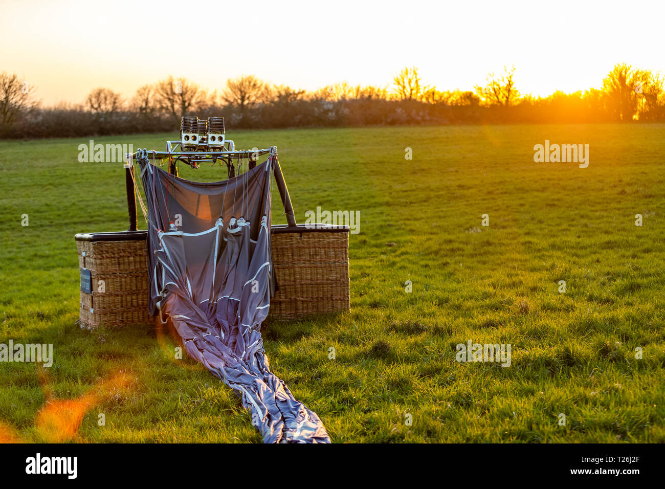 Hot air ballooning, Bristol. After an evening flight, the balloon once deflated needs to be packed away by the passengers. Stock Photo