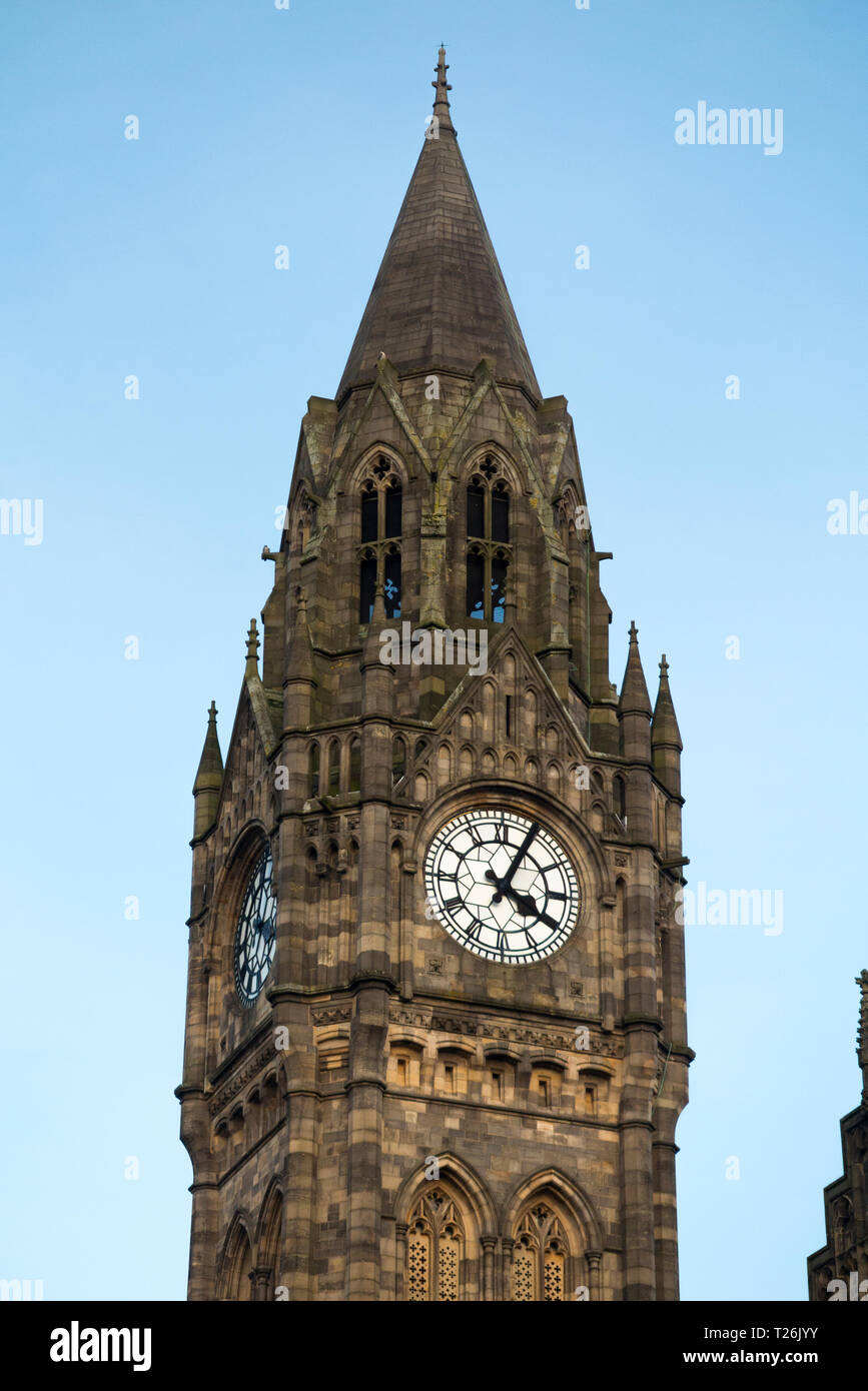 Rochdale town Hall tower clock with blue sky and late afternoon sun