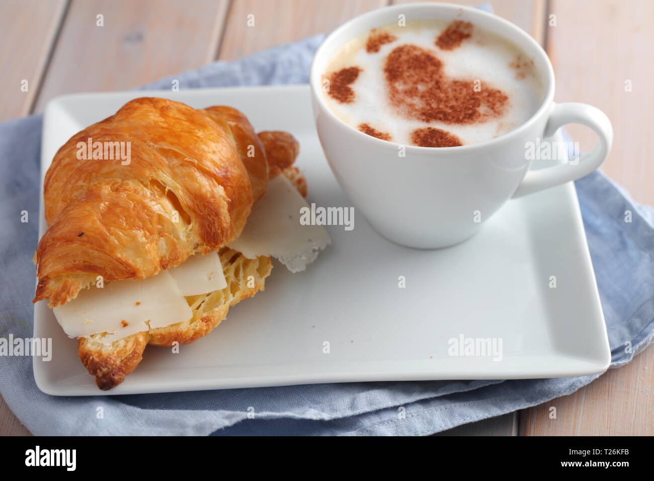 French breakfast: croissant sandwich with cheese and a cup of coffee cappuccino Stock Photo