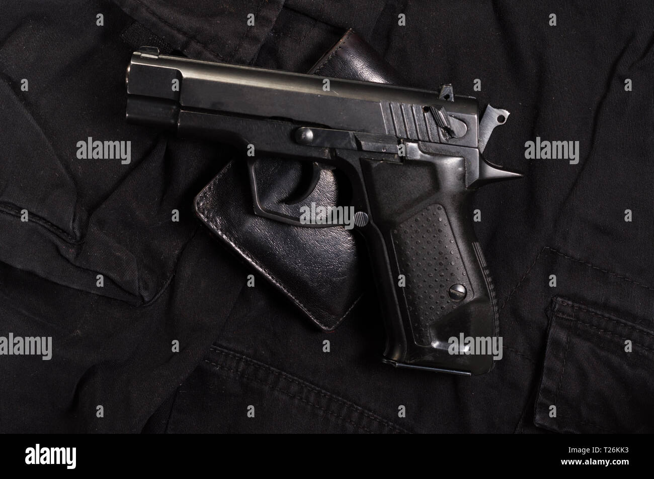 Pistol and leather wallet. Wallets and gun. Top view on the gun Stock