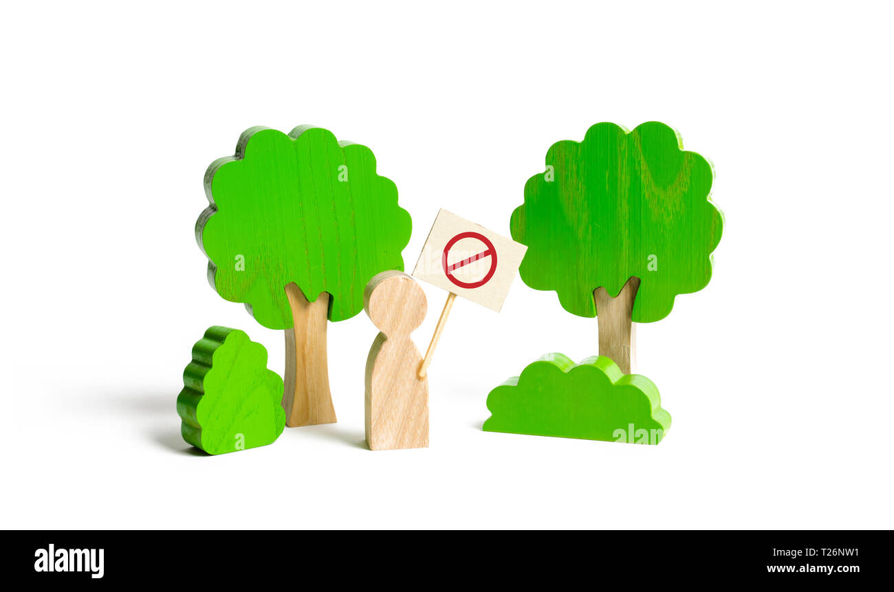 The figure of a man with a poster shows a protest in the forest. Conservation of forest from logging and nature from pollution. Nature reserves, guard Stock Photo