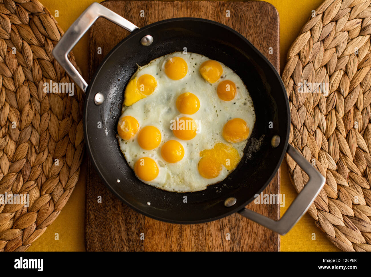 sunny side up quail eggs, fried quail eggs served in a small pan Stock