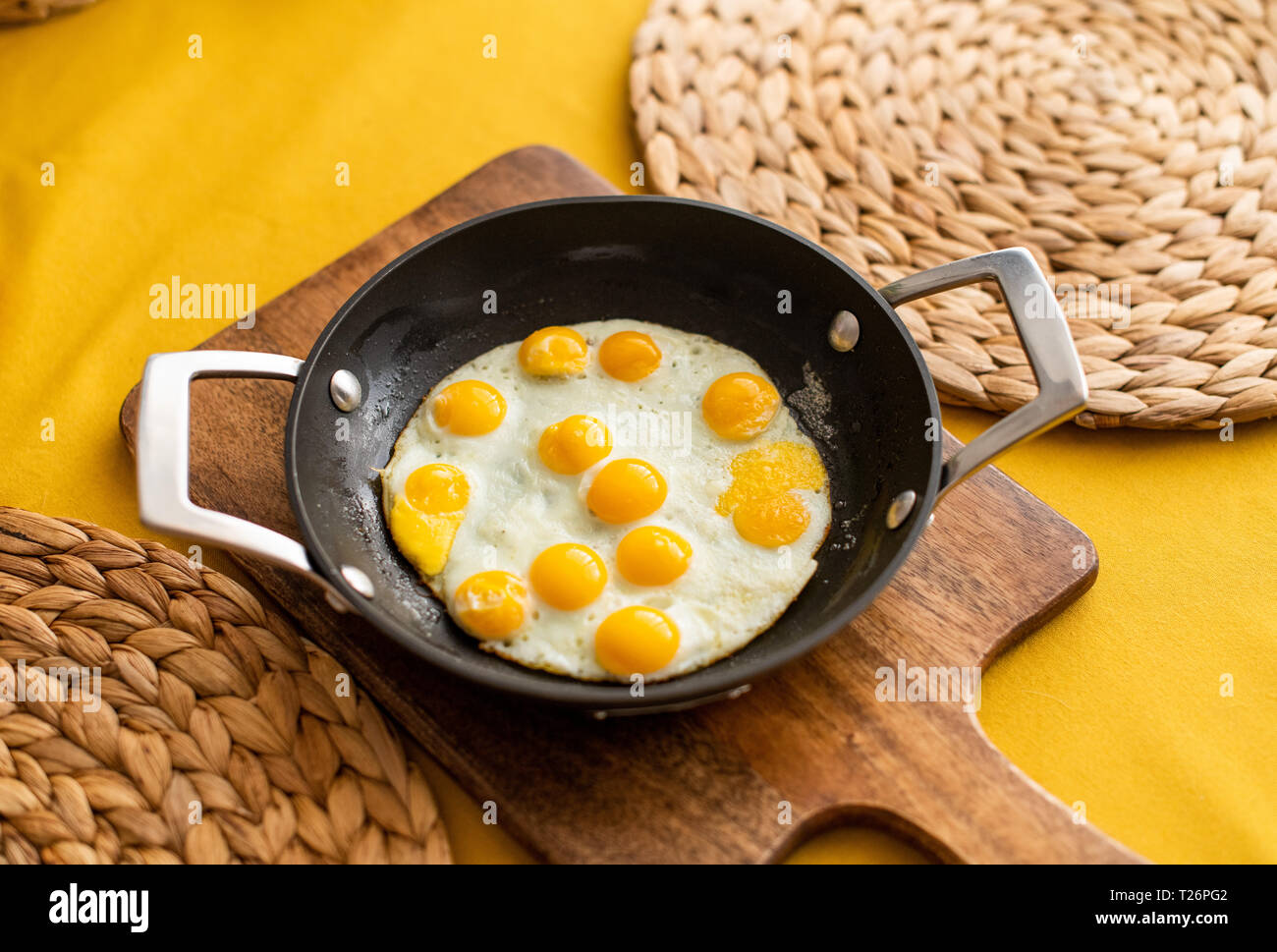 sunny side up quail eggs, fried quail eggs served in a small pan Stock