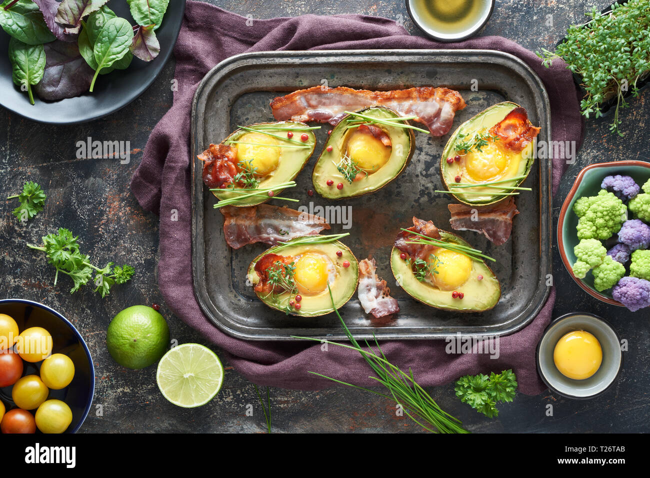 Baked Avocado With Egg And Bacon On A Metal Baking Tray Flat Lay With Baked Avocado With Egg And Bacon On A Metal Baking Tray Flat Lay With