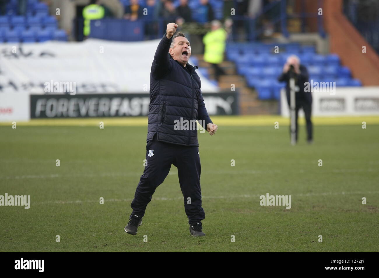 Birkenhead, Wirral, UK. 30th March, 2019. Tranmere Rovers Manager Micky Mellon salutes Tranmere fans after the EFL League Two match with Carlisle United at Prenton Park which Tranmere Rovers won 3-0. Stock Photo
