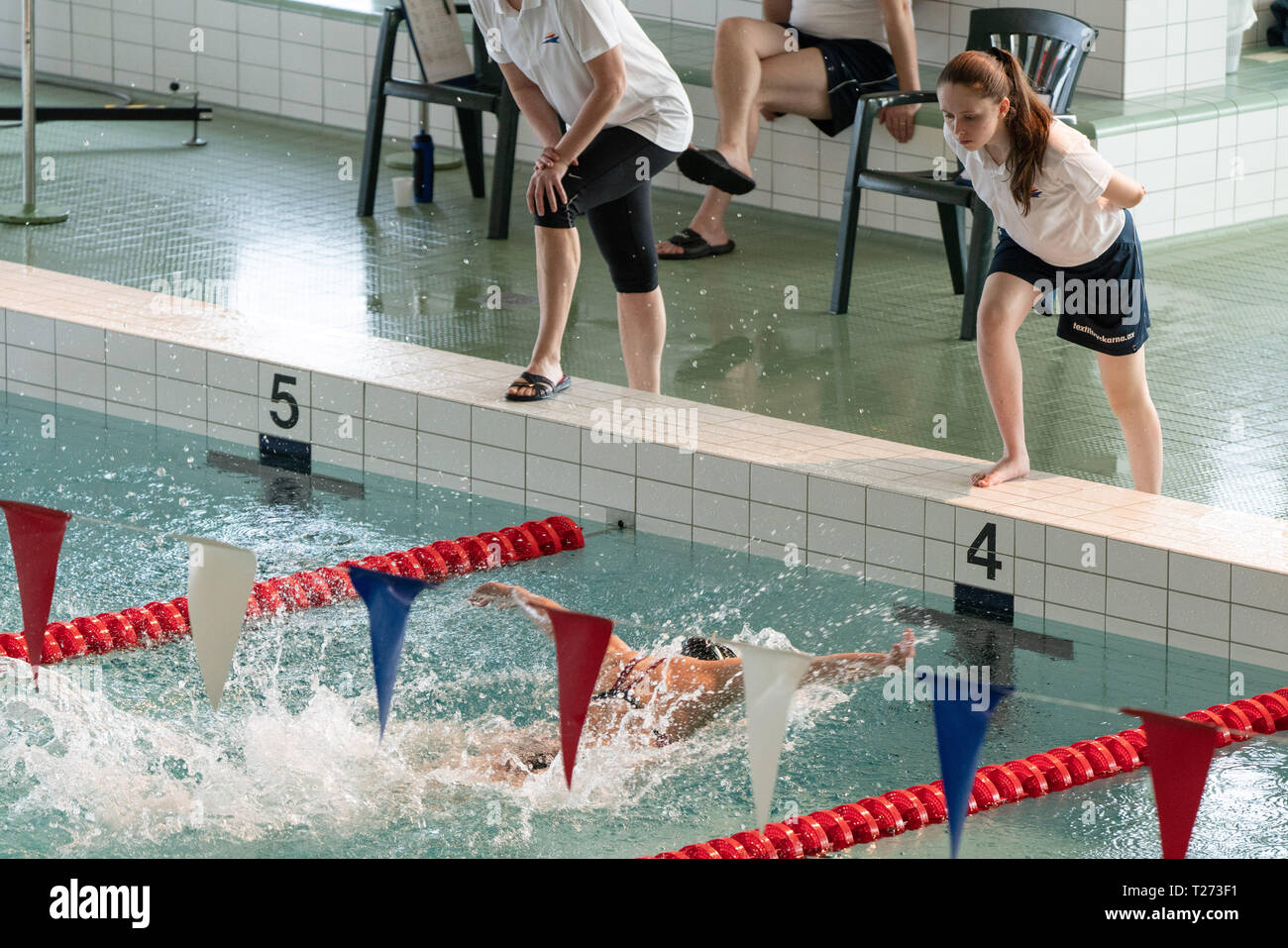 Swimmers racing in pool lanes hi-res stock photography and images - Alamy
