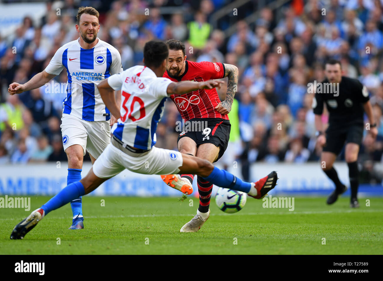 Brighton, UK. 30th March 2019.  Brighton defender Bernardo Fernandes da Silva Junior attempts to block a shot from Southampton forward Danny Ings during the Premier League match between Brighton and Hove Albion and Southampton  Editorial use only, license required for commercial use. No use in betting, games or a single club/league/player publications. Photograph may only be used for newspaper and/or magazine editorial purposes. May not be used for publications involving 1 Credit: MI News & Sport /Alamy Live News Stock Photo
