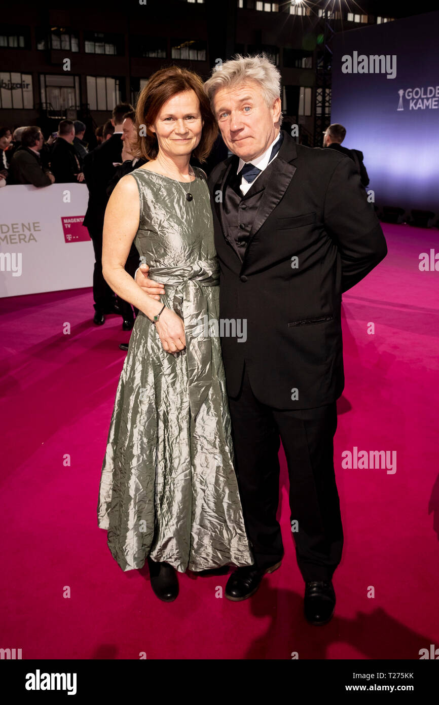 Berlin, Germany. 30th Mar, 2019. Jörg Schüttauf, actor, and his wife Martina Beeck, are standing on the red carpet before the Golden Camera award ceremony in Berlin's disused Tempelhof Airport. Credit: Christoph Soeder/dpa/Alamy Live News Stock Photo