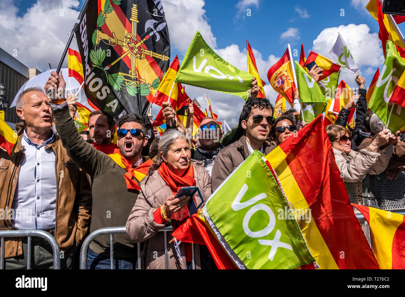 Barcelona, Spain. 30th March 2019. VOX supporters are seen holding Spanish flags during the demonstration. The political formation of Santiago Abascal has concentrated in Barcelona demanding the liberation of Catalonia, the suspension of autonomy, the dissolution of the Catalan police force and the closure of public television TV3, about two thousand people attended the event with numerous Spanish flags in the Plaza España of Barcelona Credit: SOPA Images Limited/Alamy Live News Stock Photo