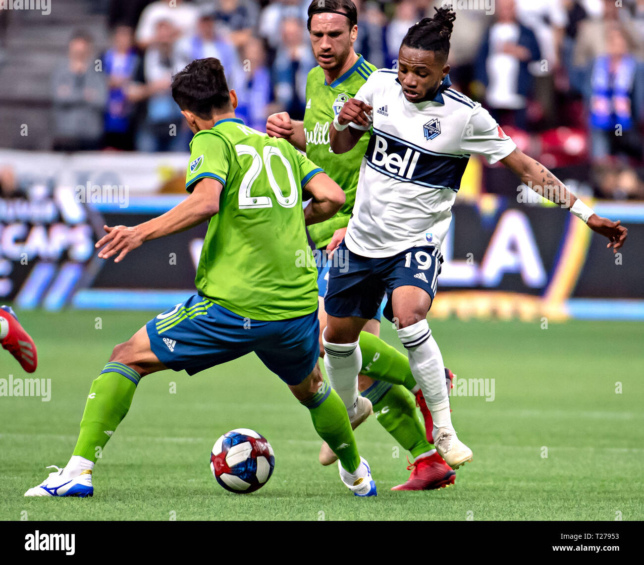 Vancouver, Canada. 30th Mar, 2019. Seattle Sounders' Kim Kee-hee (L) and Vancouver Whitecaps' Lass Bangoura compete during the MLS soccer match between Vancouver Whitecaps and Seattle Sounders in Vancouver, Canada, March 30, 2019. The match ended with a 0-0 draw. Credit: Andrew Soong/Xinhua/Alamy Live News Stock Photo
