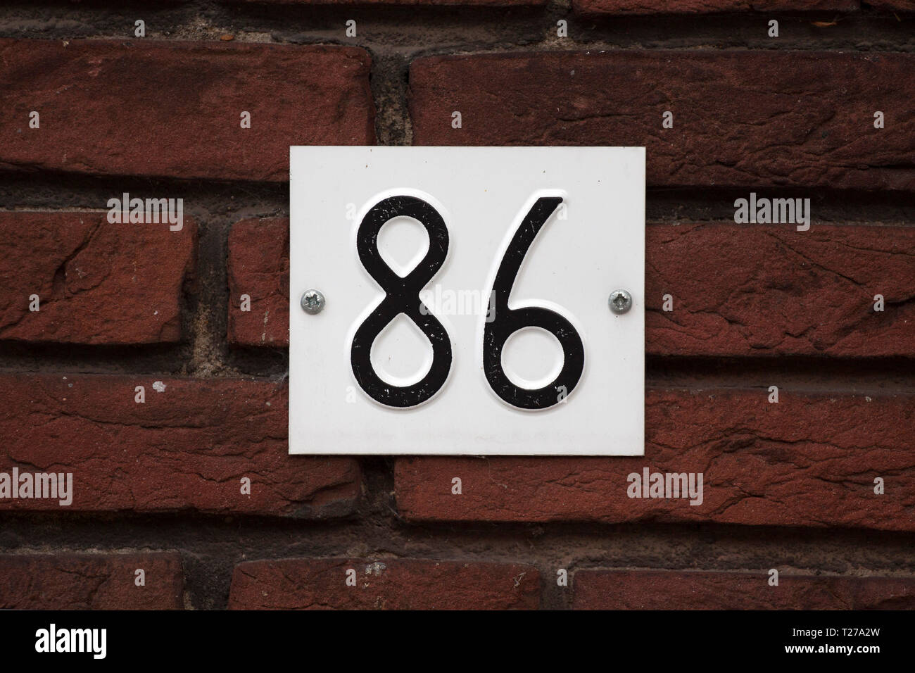 House Sign 86 House number plate eighty-six 86 screwed on a brick wall Stock Photo ...