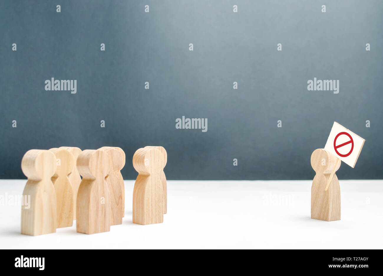 A crowd of people looking at the protesting man with a poster. Social