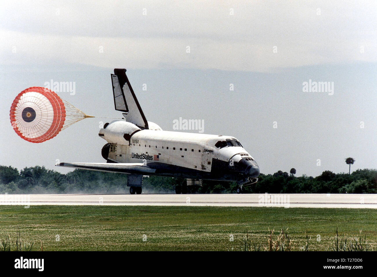KENNEDY SPACE CENTER, FLA. -- With drag chute deployed, the Space Shuttle Columbia hurtles down Runway 33 at KSCþs Shuttle Landing Facility to conclude the Microgravity Science Laboratory-1 (MSL-1) mission. With main gear touchdown at 2:33:11 p.m. EDT, April 8, the STS-83 mission duration was 3 days, 23 hours, 12 minutes. Stock Photo