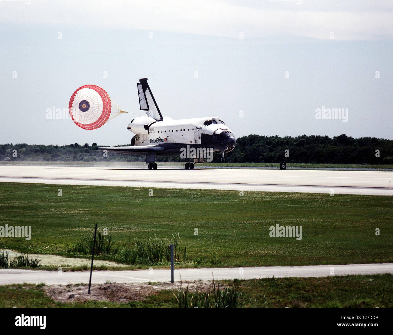 KENNEDY SPACE CENTER, FLA. -- With drag chute deployed, the Space Shuttle Columbia hurtles down Runway 33 at KSC's Shuttle Landing Facility to conclude the Microgravity Science Laboratory-1 (MSL-1) mission. With main gear touchdown at 2:33:11 p.m. EDT, April 8, the STS-83 mission duration was 3 days, 23 hours, 12 minutes. Stock Photo