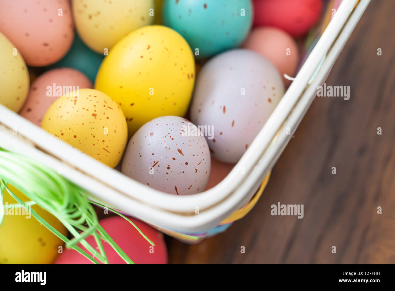 Painted Easter Eggs in brightly colored basket Stock Photo