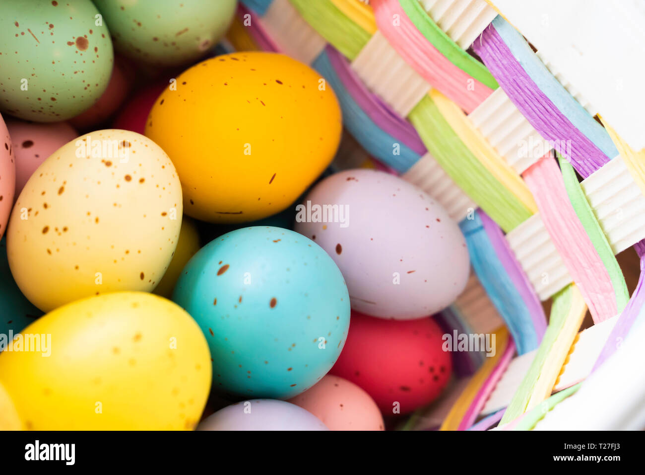 Painted Easter Eggs in brightly colored basket Stock Photo