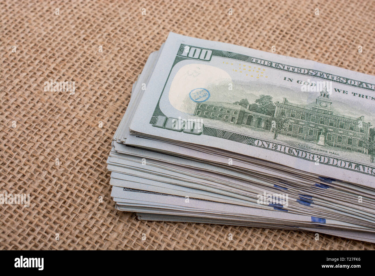 Banknote bundle of US dollar placed on a linen canvas Stock Photo - Alamy