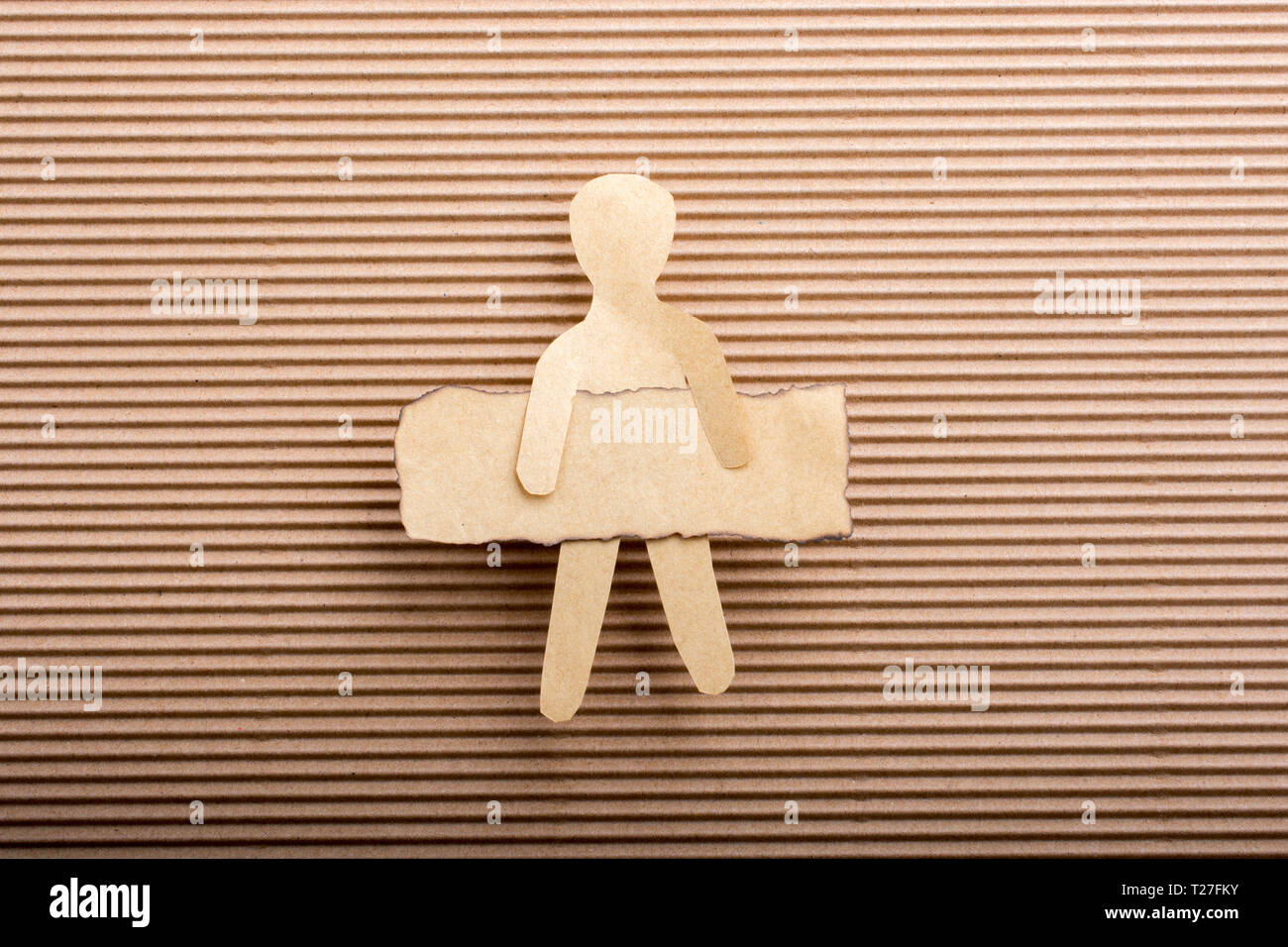 Paper man shape holding burnt note paper in hand Stock Photo
