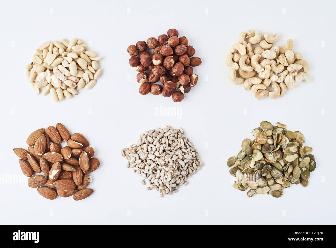 peanuts, cashews, hazelnuts, almonds, pumpkin seeds and sunflower seeds on white isolated