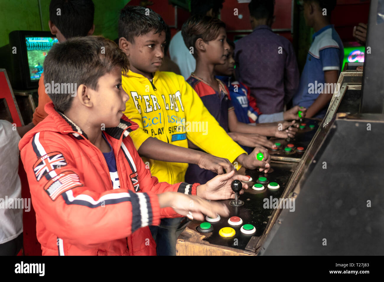 Boys play old style arcade video games in Geneva Camp, stranded Pakistanis enclave in Dhaka, Bangladesh. Stock Photo