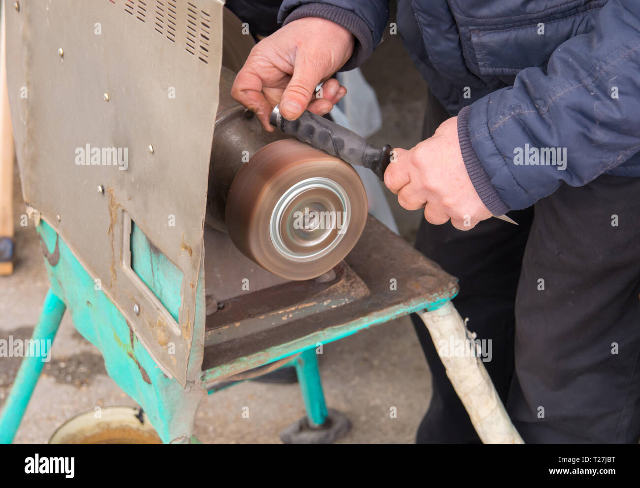 knife sharpening machine and master. Grinding machine. grinding knife using  abrasive stone Stock Photo - Alamy