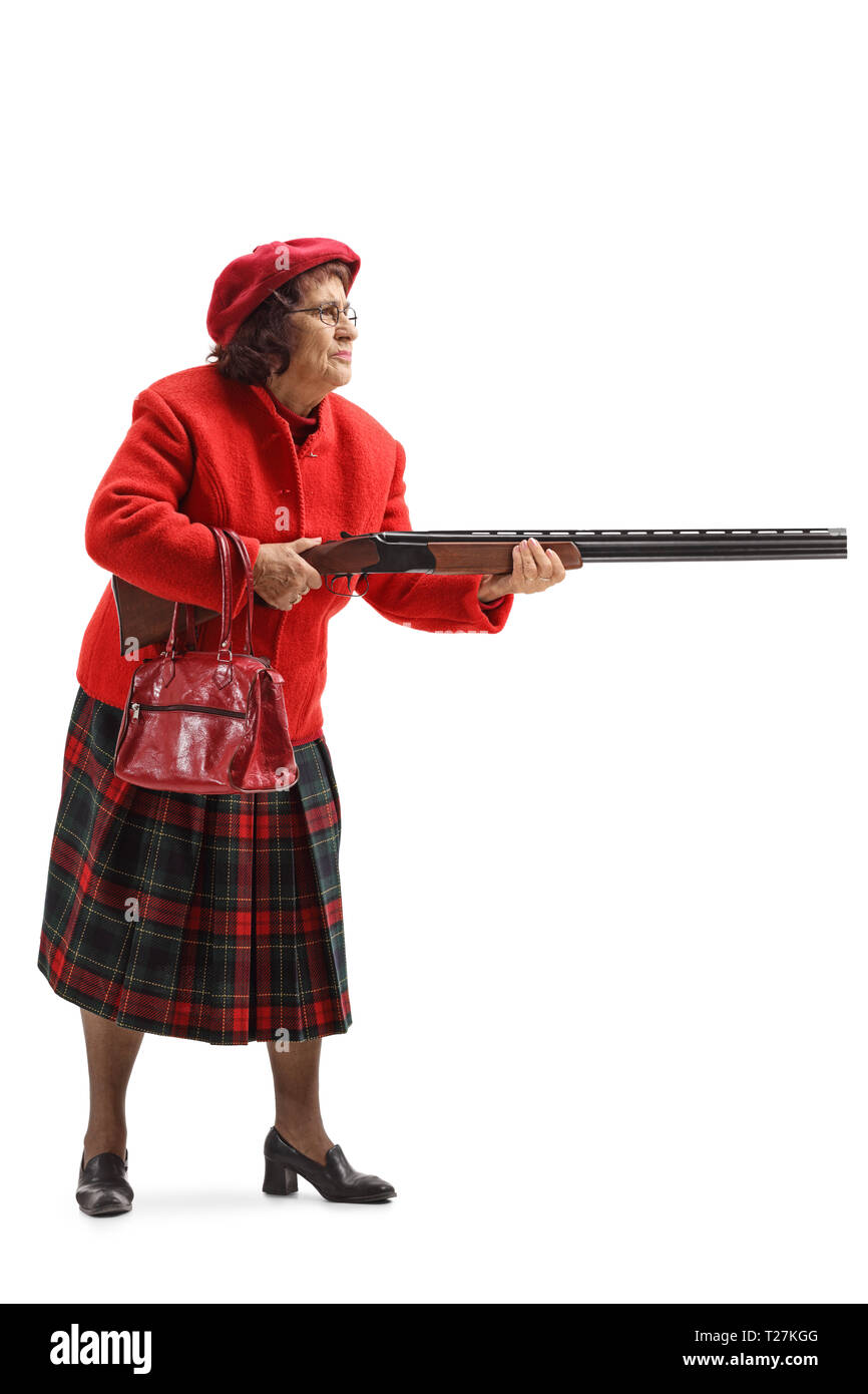 Full length shot of an old woman in a red coat holding a shotgun isolated on white background Stock Photo