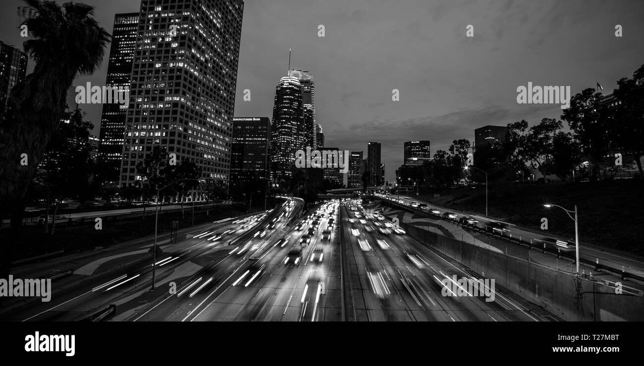 JANUARY 20, 2019, LOS ANGELES, CA, USA - California 110 South leads to downtown Los Angeles with streaked car lights at sunset Stock Photo
